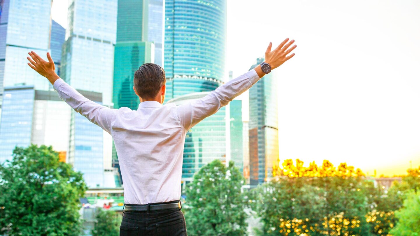 Businessman in urban city with skyscrapers buildings in the background.
