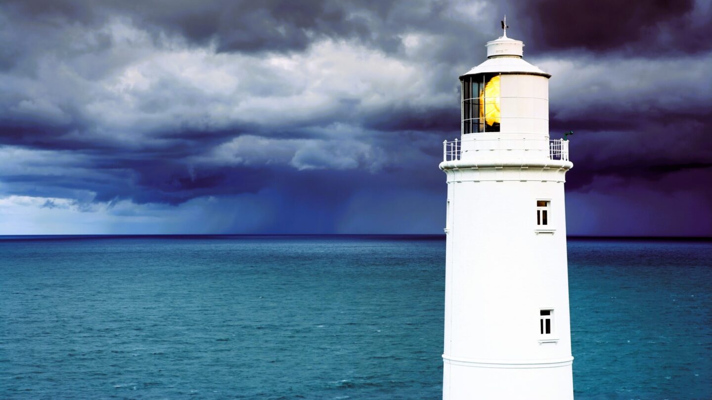Lighthouse against stormy sky